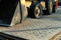 Steel plates used in road construction with a bull dozer in the background.