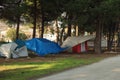 Some homeless tents in forest near road. Sad situation of America