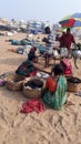 Some Indian fishing seller sitting on sea beach.