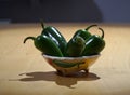 Some jalapeno peppers in a bowl on the table Royalty Free Stock Photo