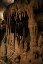 some large rock formations and lots of water pipes in a cave