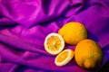 some lemons on a purple cloth