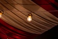 Some light bulbs hanging in the ceiling of a tent like setting Royalty Free Stock Photo