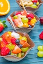 Little bowl with fruit salad on wood