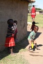 Some maasai children beside their home