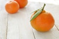 Some mandarines on a white wooden table