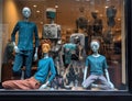 a window display of three mannequins sitting Royalty Free Stock Photo