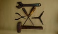 Some metal working tools on a brown background