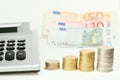 Some money coin stacks with a calculator Royalty Free Stock Photo