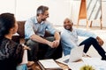 Some of the most productive meetings are informal ones. a group of businesspeople having a meeting in a modern office. Royalty Free Stock Photo