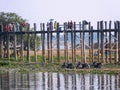 Some motorbikes are parked in front of the famous U-Bein Bridge in Burma Royalty Free Stock Photo