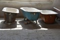 Some old used bathtubs lined up in an industrial ruin building