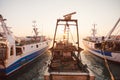 Some old wooden fisher boats are slowly rocking in harbor during a beautiful morning Royalty Free Stock Photo