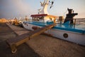 Some old wooden fisher boats are slowly rocking in harbor during a beautiful morning Royalty Free Stock Photo