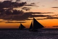 Some outrigger sailboats on the horizon