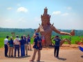Some people take pictures with the background statue of Dewi Sri, the Goddess of rice in Jatiluwih tourism object