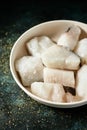 Some pieces of frozen uncooked codfish