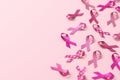 Some pink ribbons isolated on a pink background with copy space for Breast Cancer Awareness Month and World Cancer Day. Flyer Royalty Free Stock Photo