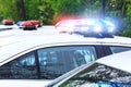 Some police cars with focus on siren lights. Beautiful siren lights activated on a police car before leaving the department park. Royalty Free Stock Photo