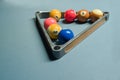 Some pool balls in the metal triangle ball rack on pool table Royalty Free Stock Photo