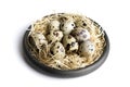 Some quail eggs in a black ceramic bowl