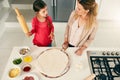 Some quality time with my daughter. High angle shot of a middle aged mother and her daughter preparing a pizza to go Royalty Free Stock Photo