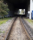 Rails leading under overpass