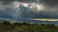 Some rays of sunshine slip between the storm clouds Royalty Free Stock Photo