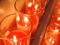 Some red candle burning in a church Royalty Free Stock Photo