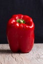 Some red, green and yellow bell peppers over a wooden surface Royalty Free Stock Photo