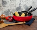 Some of red pans and a apron and a spoon Royalty Free Stock Photo