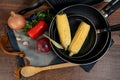 some red pans with vegetables and a wooden spoon Royalty Free Stock Photo