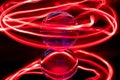 Some red rings surround a crystal clear glass ball on a mirror Royalty Free Stock Photo
