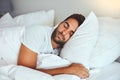 Some rest after a hard days work. a handsome young man sleeping comfortably in his bed at home. Royalty Free Stock Photo