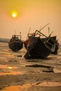 Some resting boats on the beach during sunset