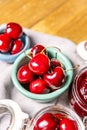 some ripe cherries in glass jars, a green porcelain