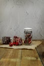 some ripe cherries in transparent glass jars