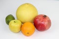 Some ripe fruit on a white background: pomegranate, pomelo, orange, avocado, Apple Royalty Free Stock Photo