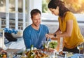 Some salad, dear. a happy married couple enjoying lunch together outside. Royalty Free Stock Photo