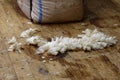 Some scraps of fleece are on the floor in front of the wool bale