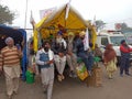 Some sikh farmers are sitting on a trolley and watching others photograph