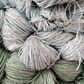 Some skeins of natural raffia of different colors on shelf. Natural material for knitting, crocheting, creative idea. Abstract diy Royalty Free Stock Photo