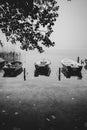 Some small rowboats lie on the shore of a lake in the fog Royalty Free Stock Photo