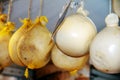 Some south Italian caciocavallo cheese hanging in a delicatessen.