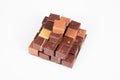 Some square pyramid chocolate pralines in top view in white background