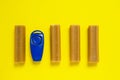 Some sticks of dog delicacy and clicker, special training appliance, on bright yellow background