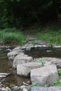 Stones building a bridge over a river