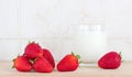 Some strawberries and a glass of milk