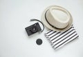 Flat lay of a straw hat, a photocamera and a stripped T-shirt. V