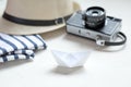 Flat lay of a straw hat, a photocamera and a stripped T-shirt. V